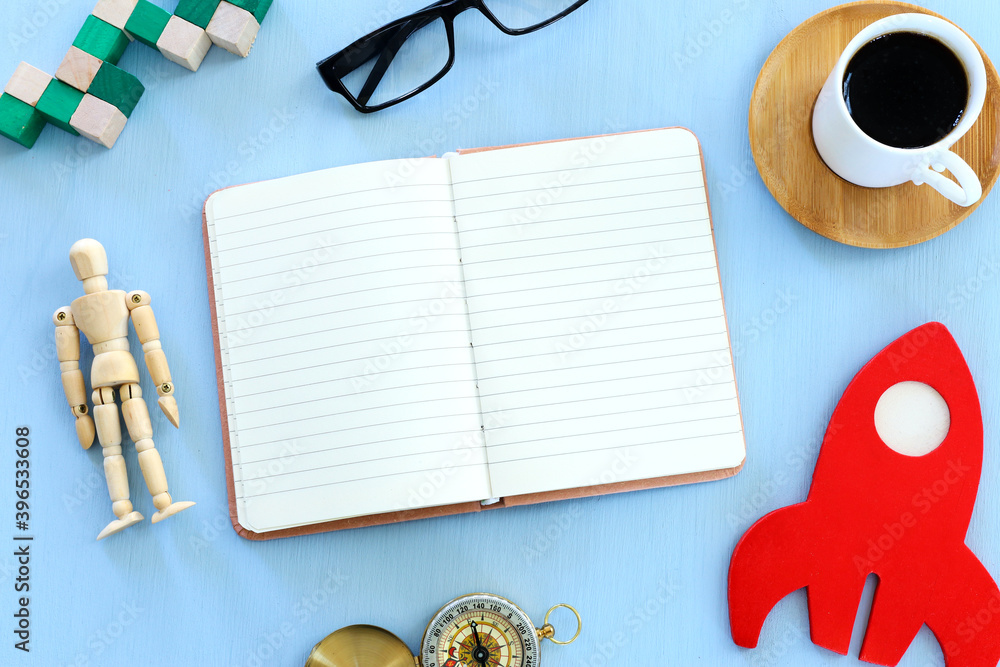 Fototapete top view image of open notebook with blank pages next to cup of coffee on wooden table. ready for ad