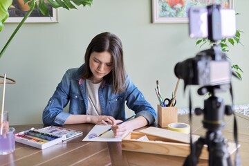 Art workshop online, teenage girl drawing with watercolors