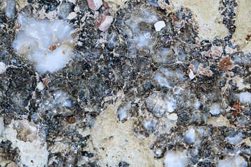 Diverse colored quartz rock in cut of the earth. Deposits of gray, white, orange quartz. Untreated...
