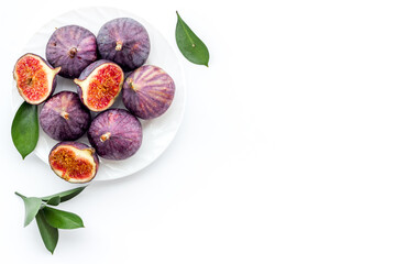 Fresh ripe figs in on plate with leaves. Mediterranean fruit background