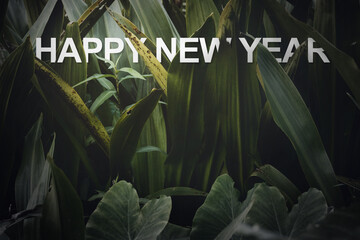 Floating paper letters and numbers of . 2021 happy new year on Green leaves  background,Nature eco concept with copy space for adding text.