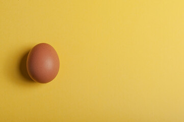 An egg on a yellow background Zenital view