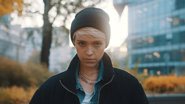 Portrait of blond woman with winter hat and jacket looking angy at the camera. High quality photo
