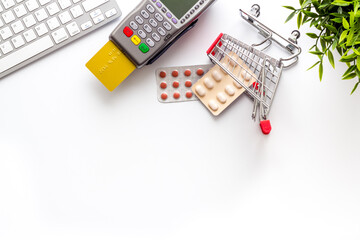 Fototapeta premium Healthcare insurance concept - payment terminal with a bank card, top view