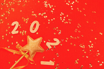 Obraz na płótnie Canvas Christmas composition with decorative golden star and 2021 figures on colorful background with sequins.