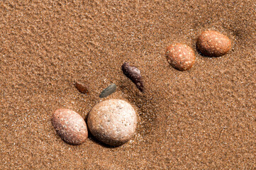 Fototapeta na wymiar Pebbles on red sand