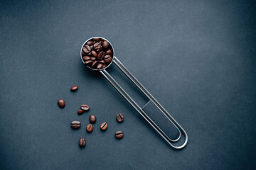 metal silver measuring spoon with coffee beans