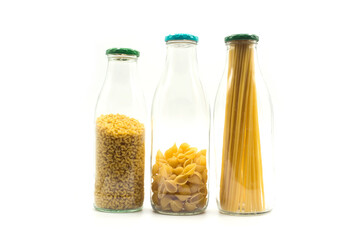 Closeup of pasta collection in a transparent glass container on white background