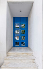 modern family house entrance, white-washed walls and blue door, Athens, Greece,