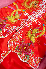 Close up details of traditional Chinese Wedding Dress with phoenix embroidery.