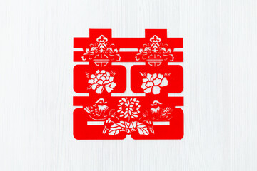 Chinese traditional paper-cut art of Chinese symbol of double happiness with two mandarin ducks.