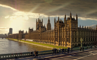 London England, the British parliament and Thames river under dramatic sky