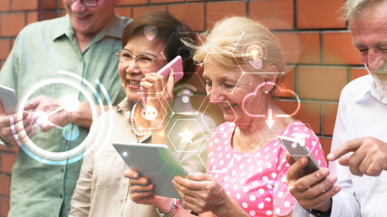 Group of diverse elderly using digital devices