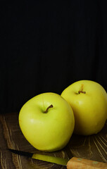 Close up, apple on rustic table, next to an old knife