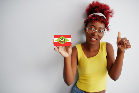 Brazilian woman with afro hair hold Santa Catarina flag isolated on white background, show thumb up. States of Brazil concept.