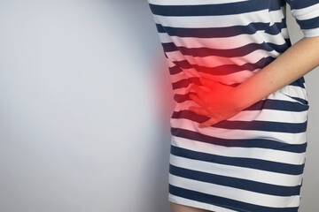 A woman holds on to his stomach. Pain in the abdominal cavity. The concept of diseases of the...