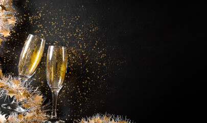Christmas and New Year holidays background concept made from champagne glasses with golden glitter...