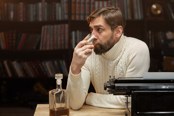 A thoughtful, concerned male writer working on a novel on a typewriter, drinking alcohol while thinking about solving a problem in the home office, a serious person looking for inspiration.