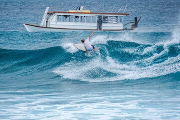 Obraz premium Surfer on perfect blue aquamarine wave, empty line up, perfect for surfing, clean water, Indian Ocean