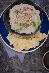 Middle Eastern baba ganoush eggplant dip with corn chips, copy space