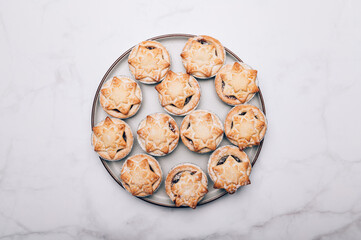 Mince pies, traditional christmas food from all butter shortcrust pastry filled with cranberries, sultanas, currants, raisins, along with festive spices, clementine juice, dash of brandy and cognac