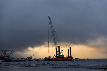 Fototapeta premium Construction Marine offshore works. Dam building, crane, barge, dredger. Breakwater construction.
