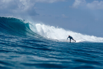 Surfer on perfect blue aquamarine wave, empty line up, perfect for surfing, clean water, Indian Ocean .