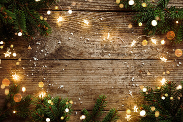 Merry Christmas frame made of Christmas decorations, fir branches, spruce, lights garland,...