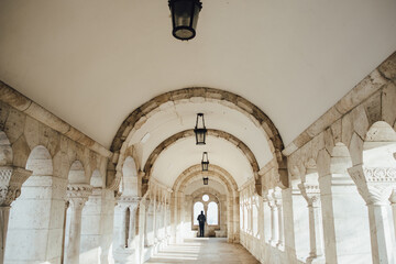 Fototapeta premium Arch, interior of Fisherman Bastion in Budapest, Hungary. Unrecognisable man in the corridor