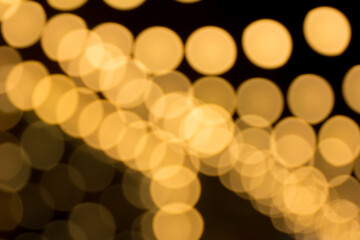 Defocused garland lights, Bokeh effect. Sparkling and fairy background. Christmas and New Year holidays concept.