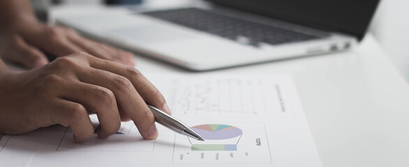 Close-up photo of a business woman holding a pen And read summary reports, business ideas.