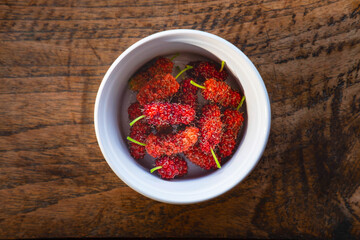 .Healthy fresh mulberry fruit in a bowl on the table