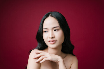 Asian woman healthy skin concept natural make up isolate on red background.