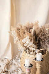 Pampas grass and lunaria are collected in a bouquet for room decor. Bouquet of dried flowers. Floral minimal home interior boho style. Boho style holiday photo zone decor