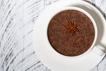 cup of hot spiced chocolate on white background, top view
