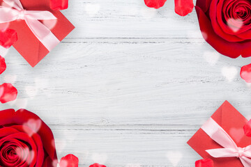 Valentines background with red rose, valentine envelope and heart shaped bokeh on the wooden table, flat lay with copy space, frame