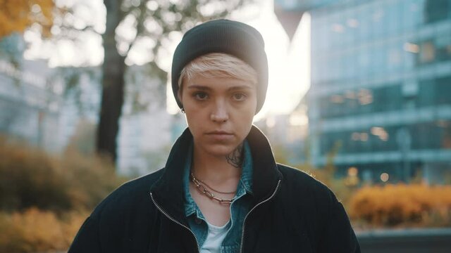 Portrait of blond woman with winter hat and jacket looking angy at the camera. High quality 4k footage