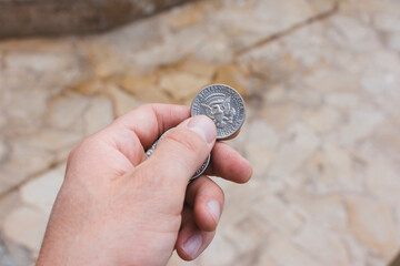 Hand holding half dollar coins