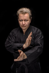 Portrait aikido master wearing traditional samurai hakama clothes. on black Background