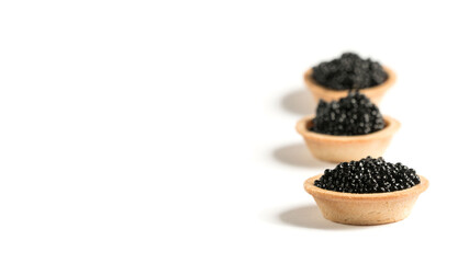 Fototapeta na wymiar black caviar on a white plate. tartlet with black caviar. snack.