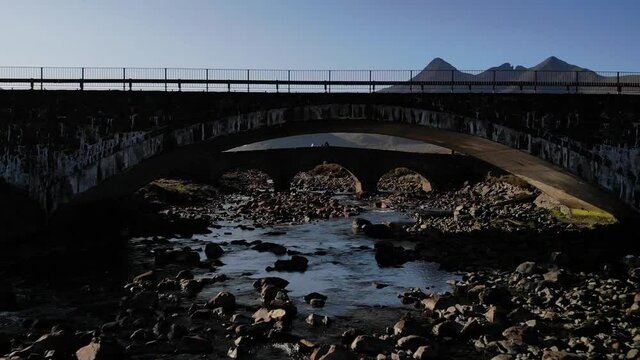 Aerial shot of Sligachan Old Bridge and the Cuillin Hills, Isle of Skye, Scotland.
