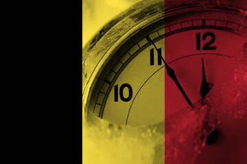 Belgium, Belgian flag with clock close to midnight in the background. Happy New Year concept