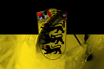 Germany, German, Deutschland, Baden Wurttemberg flag with clock close to midnight in the background. Happy New Year concept