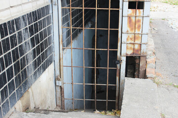 The exit is visible on the side facade of the residential building
 from an air-raid shelter fenced...