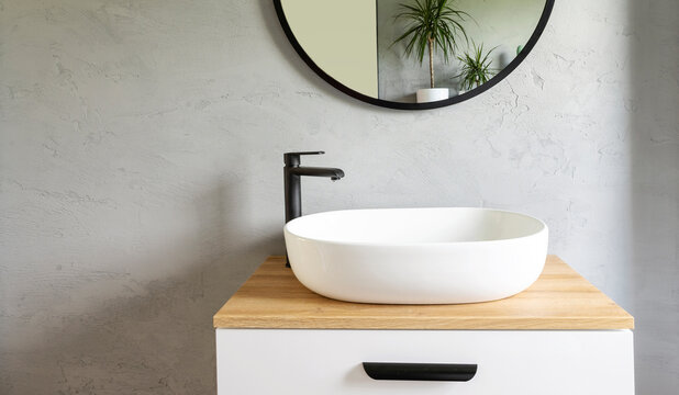 Bathroom interior  with grey wall, stylish sink bowl and tap. Minimalism in interior of bathroom. Spa at home. Scandinavian design.