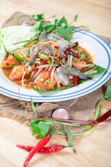 Fresh shrimp green papaya salad.Thai Style spicy seafood salad with shrimps isolated on the white background with clipping path.
