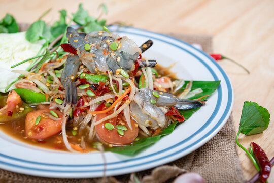
Fresh shrimp green papaya salad.Thai Style spicy seafood salad with shrimps isolated on the white background with clipping path.
