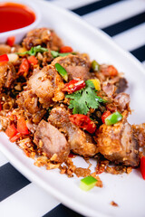 Fried Crispy Pork  On a white plate- Thai food style
