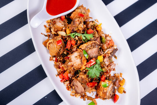 Fried Crispy Pork  On a white plate- Thai food style
