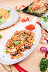 Fried Crispy Pork  On a white plate- Thai food style

